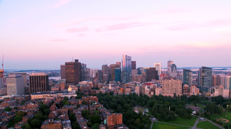 A panoramic view of Boston's skyline with its iconic buildings and green spaces