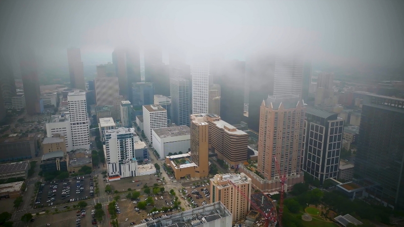 Aerial view of Houston's downtown with its towering buildings and misty weather