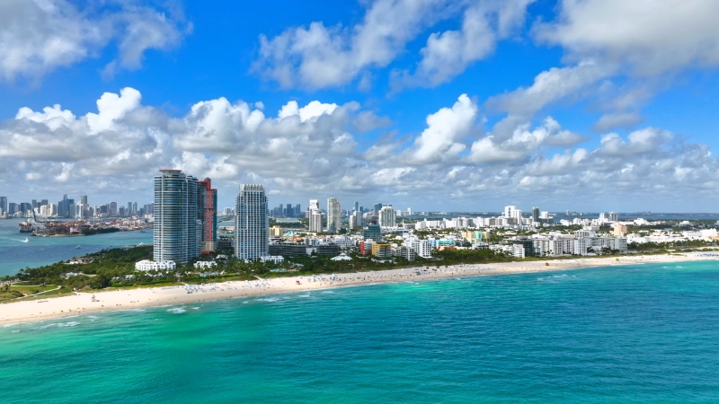 Aerial view of Miami's skyline, beaches, and turquoise waters, showcasing its coastal cityscape