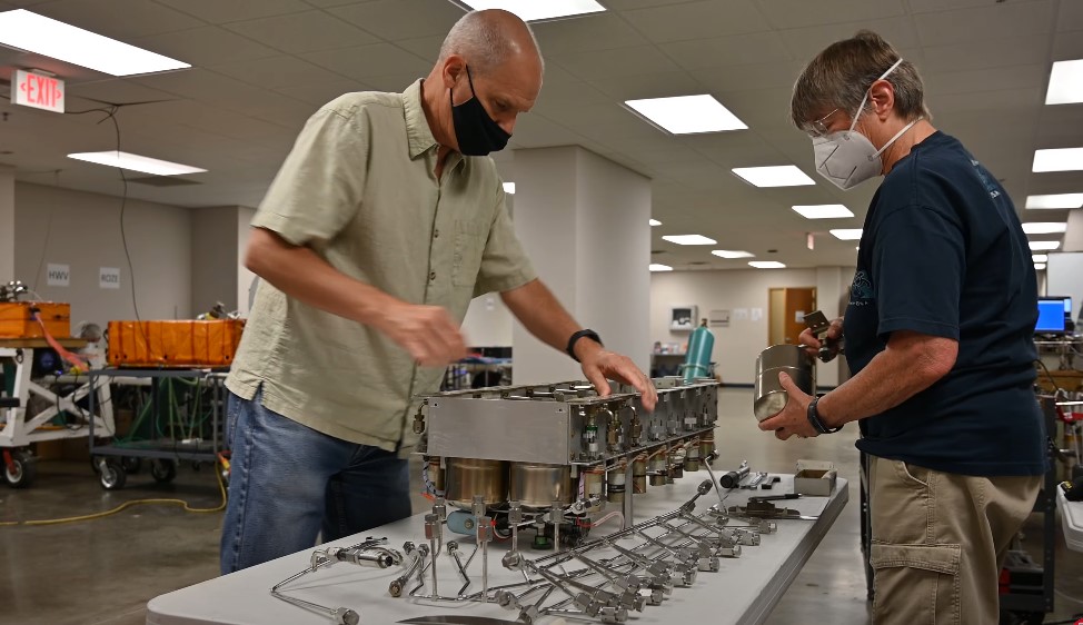 Focused technicians examine air quality from a tube