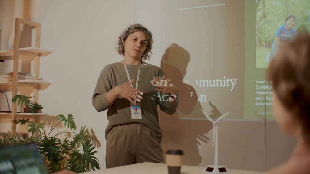 Woman giving a presentation on climate awareness at a community event