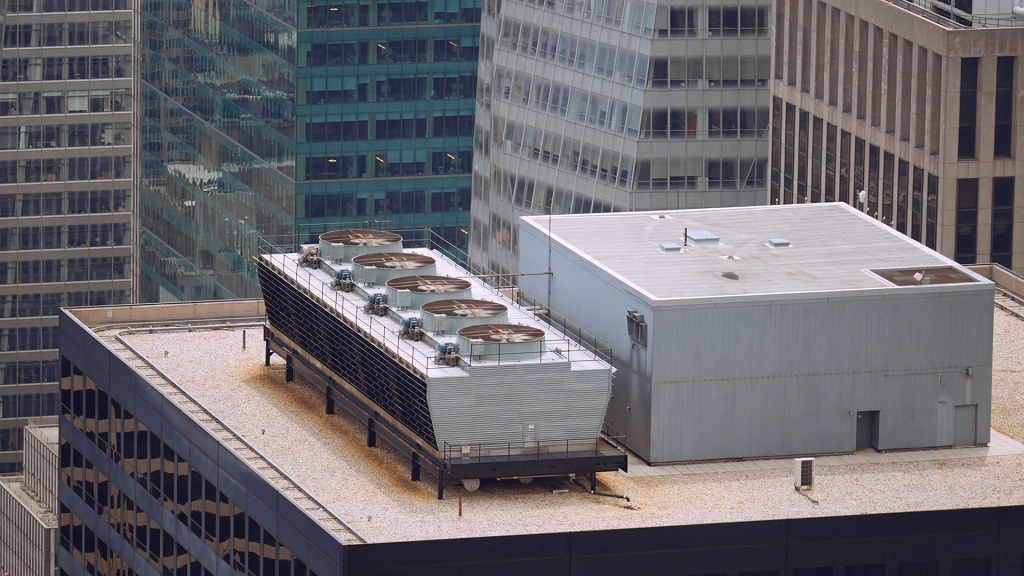 Rooftop HVAC system on a tall office building surrounded by skyscrapers