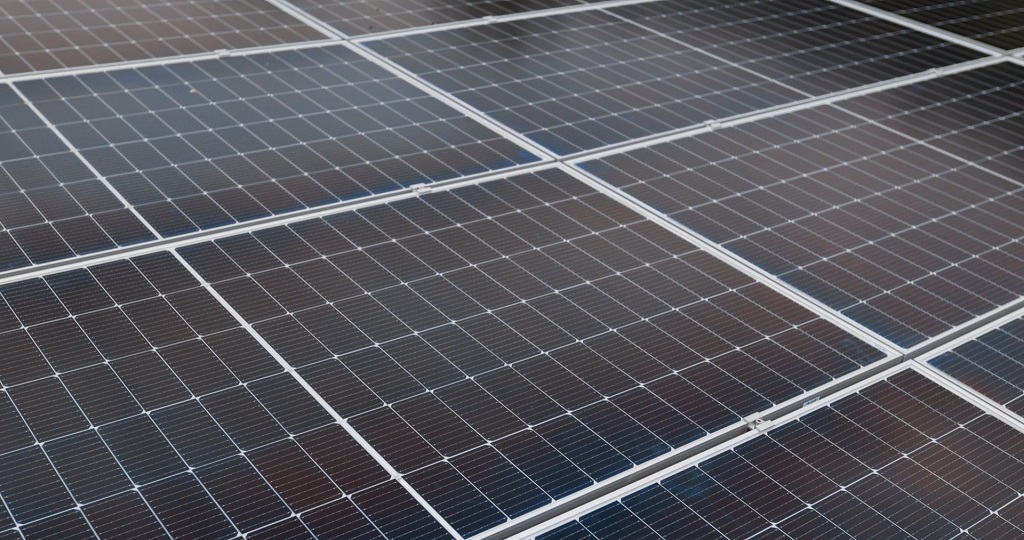Close-up view of installed solar panels showing grid structure and reflective surface