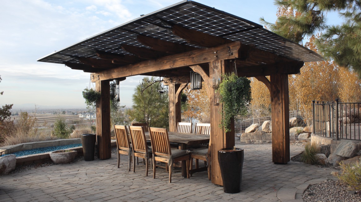 Rustic wooden solar pergola with dining area and mountain view in the background