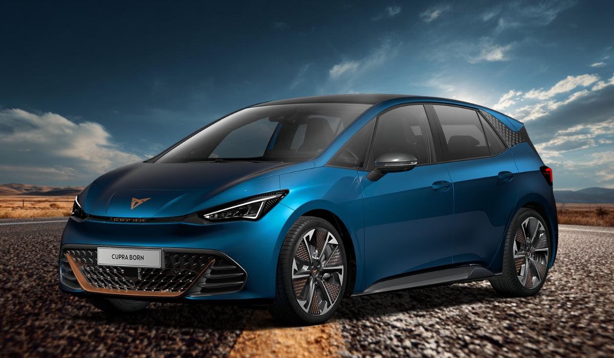 A sleek blue CUPRA Born electric hatchback parked on a scenic road with a dramatic sky and open landscape in the background