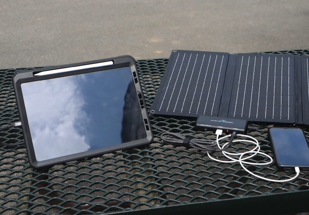 foldable solar panel charging phone and tablet simultaneously outdoors
