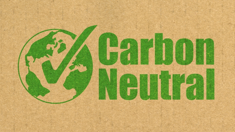A green carbon neutral logo with a check mark appears on recycled cardboard to show certified climate commitment