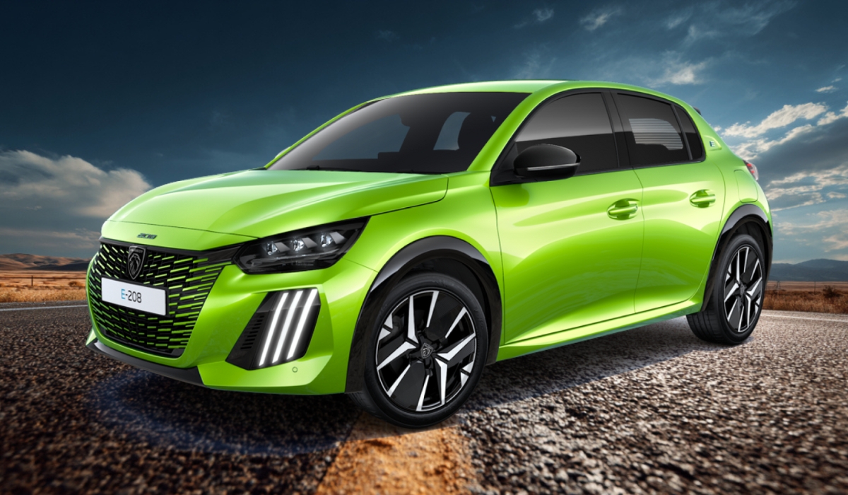 A bright green Peugeot e-208 electric car parked on a road with scenic mountains and a blue sky in the background