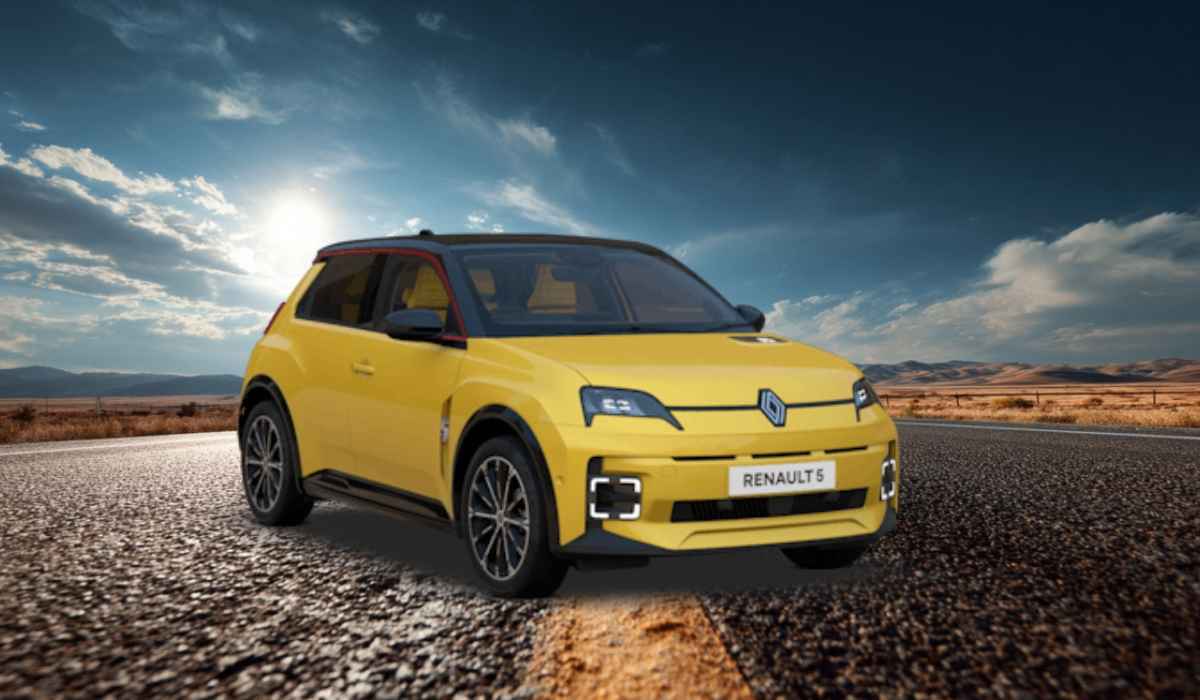 A yellow Renault 5 E-Tech electric car parked on a scenic road with a bright sky and open landscape