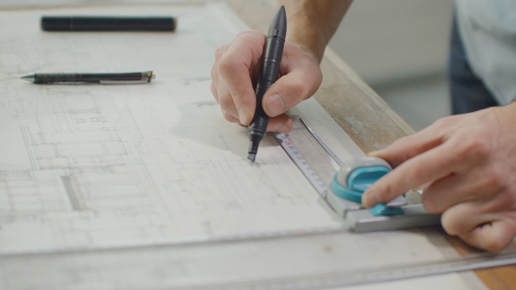 Architect drawing blueprints for a construction project