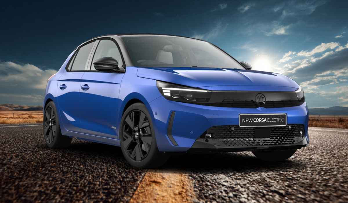 A blue Vauxhall Corsa Electric car parked on a road with a scenic sky and mountains in the background