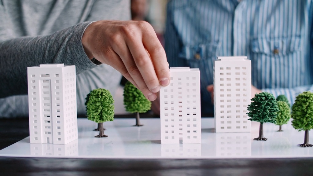 Planners working on a scale model of a building project
