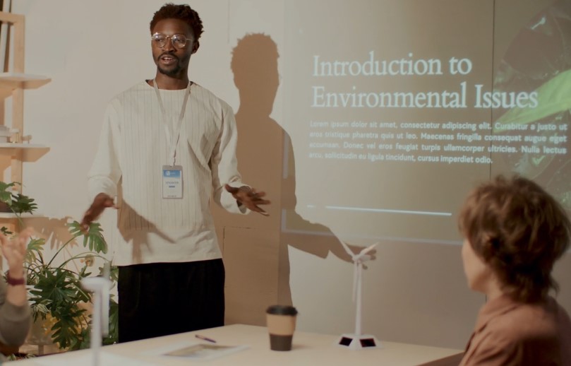 A presentation on environmental issues unfolds, with a speaker passionately engaging the audience