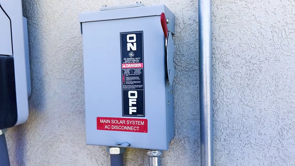 Main solar system AC disconnect switch mounted on a wall, used for inverter and electrical safety maintenance.