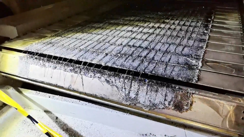 Solar panel laminate heated in industrial furnace during thermal delamination recycling process