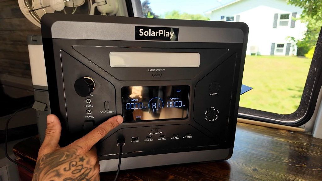 Portable power station connected to a solar charging setup inside a van used for off-grid energy storage