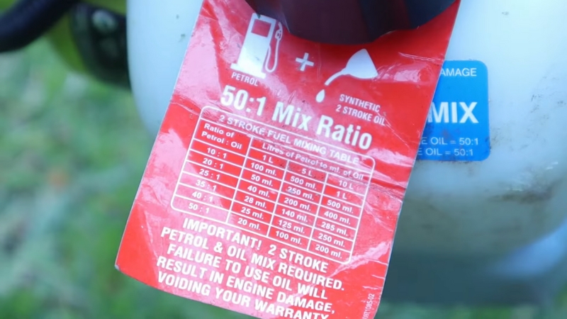 Close-up of a fuel container label showing a 50:1 two-stroke fuel mix ratio chart