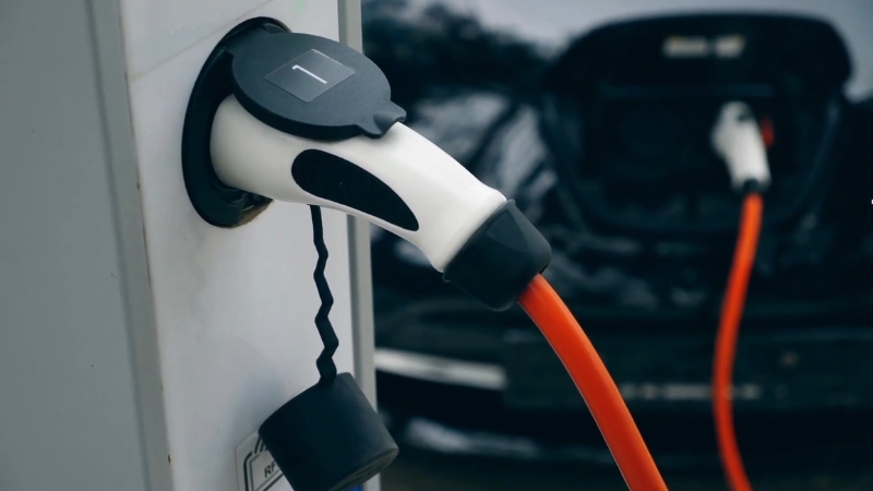 EV charging station cable plugged into an electric vehicle during charging