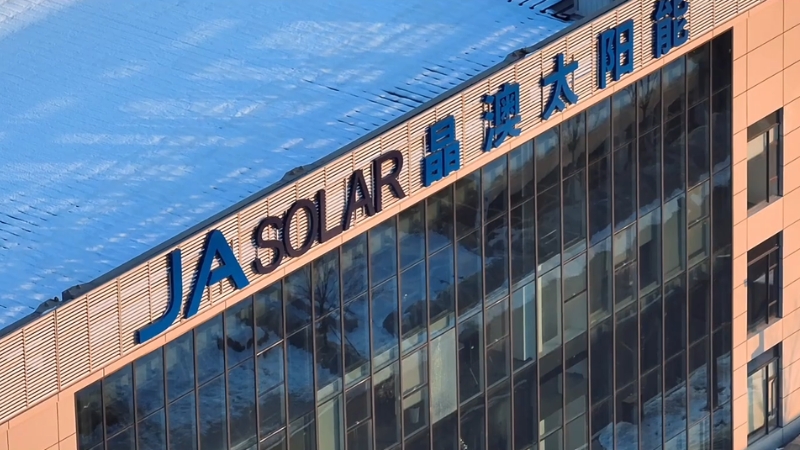 JA Solar company logo displayed on the exterior of a modern office building