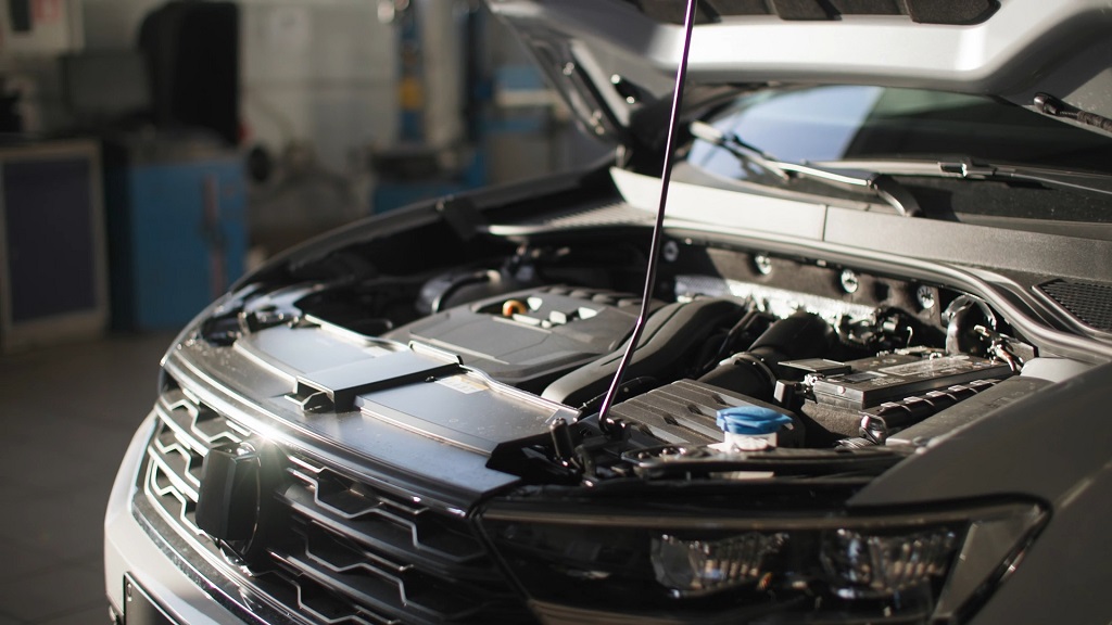 Open car hood showing engine bay during inspection