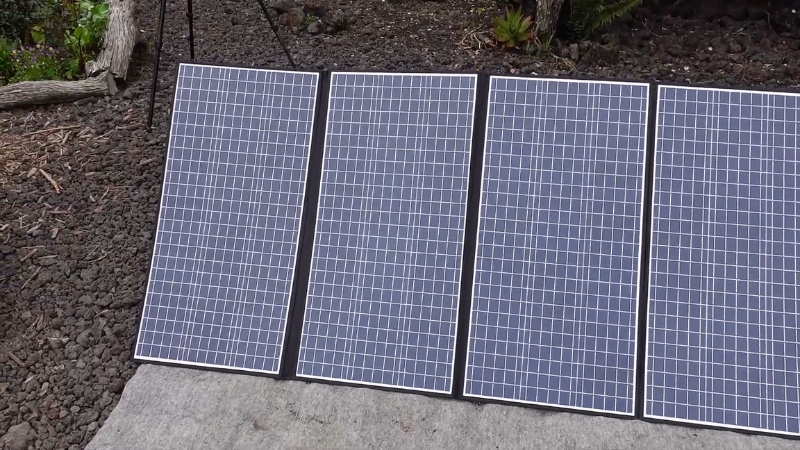 Four 400W solar panels standing outdoors on a concrete surface ready to generate power