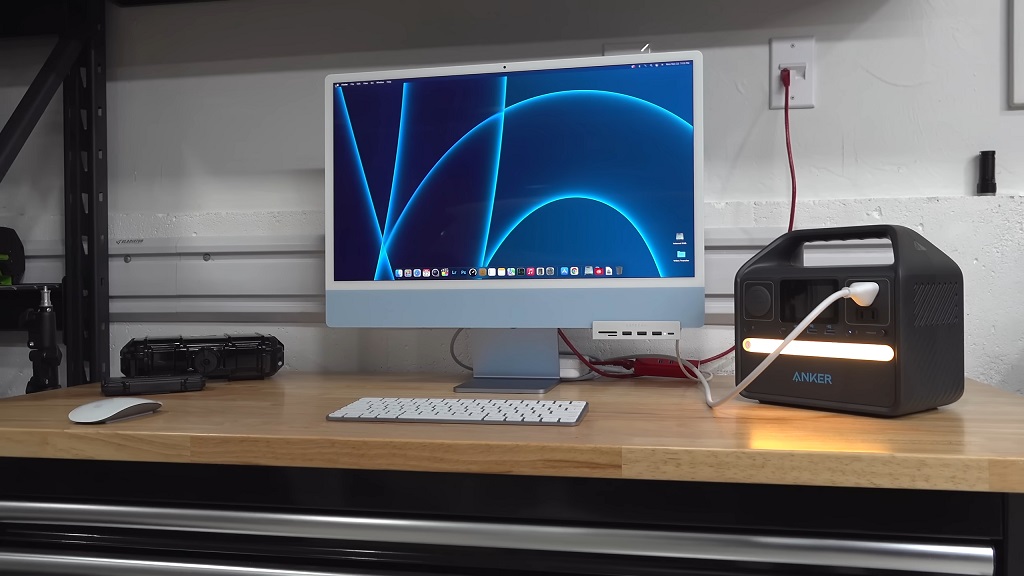 A computer connected to a portable power station during a power outage